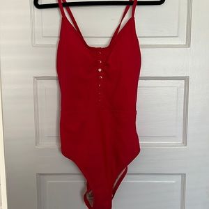 Red one piece swimsuit with crossed back tie. Size Large. Excellent condition.